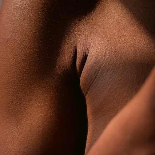 Close-up of a shoulder with dry skin in warm light